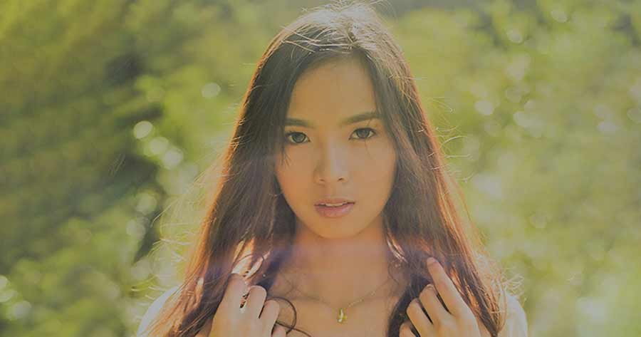  A photo of a long-haired Filipino girl in a yellow lace dress